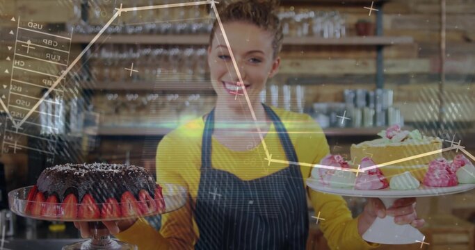 Naklejki Smiling pastry chef showcasing cake stands in bakery, with chocolate bundt cake and frosted cake