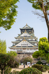 Osaka Castle during a spring day with cherry blossom trees. , Osaka, Japan