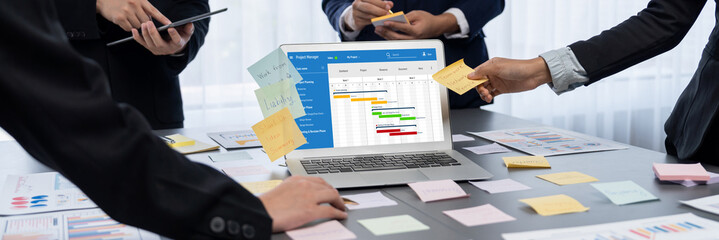 Project planning software for brisk business project management on the computer screen showing...