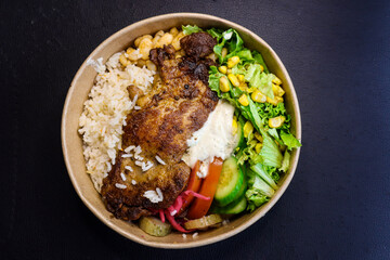 Grilled chicken rice and salad bowl close-up