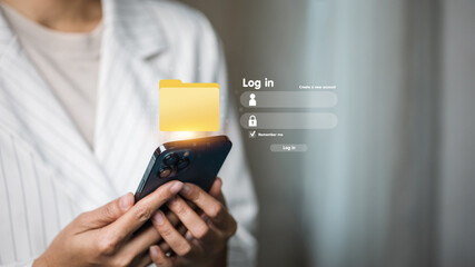 Businessman login smartphone with digital file folder icon, online data access and cybersecurity concept