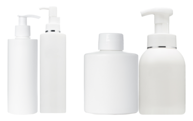 photograph of four blank white plastic cosmetic dispenser bottles with silver accents and pump tops, ideal for branding mockup display.