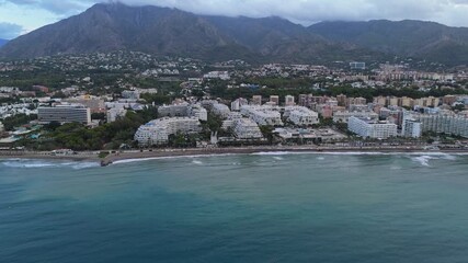 Aerial Landscape views of Marbella coastal city. Marbella is a city and resort area on southern Spain’s Costa del Sol, part of the Andalusia region. Ambient drone exploration.
