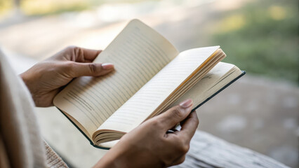Obraz premium Reading book sustainable living concept with hands holding open pages outdoors peaceful moment