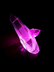 Shining Magical Pink Quartz Crystal on a Dark Dramatic Black Background