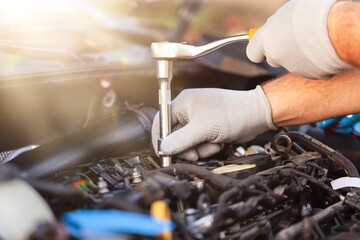 Car mechanic working with motor of a car.