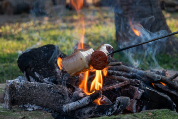Traditional hungarian campfire cooking - bacon and sausage