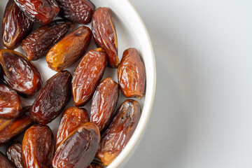Date fruits in white bowl