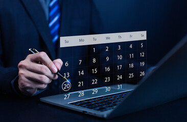 Businessman planning schedule on laptop with digital calendar interface, symbolizing time management, business planning, and online scheduling concept for productivity and organization.