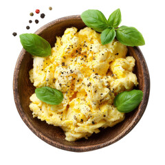 Scrambled eggs are served in a wooden bowl with basil leaves and black pepper for added flavor and freshness
