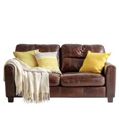 A comfortable leather couch showcases colorful pillows and a warm throw blanket in a sunny living room