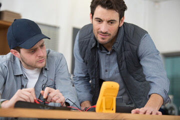 team of electricians measuring the voltage