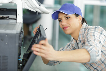 woman is fixing a machine