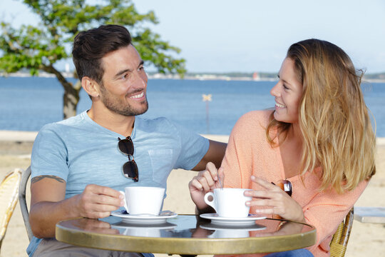 young copule having coffee in lounge bar outdoor
