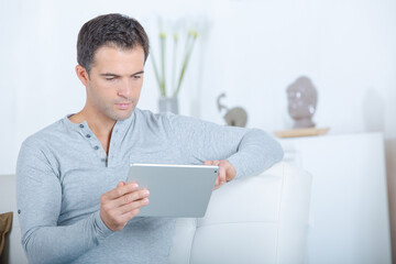 man at home on tablet