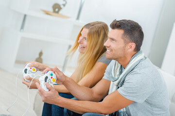 Couple at home playing computer game