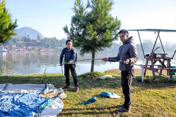 Friends on a Camping Trip, Preparing Their Campsite and Setting up their Tent on the Grass