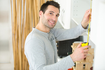 man assembles wardrobe