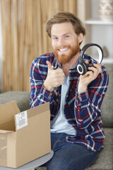 young man receiving delivery of headphones