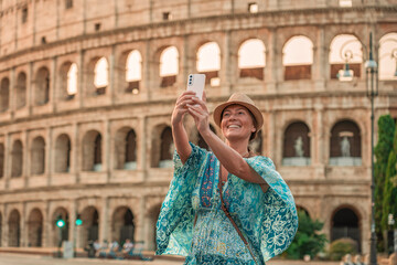 08 08 2025 Rome, Italy - Female tourist taking selfie near Colosseum