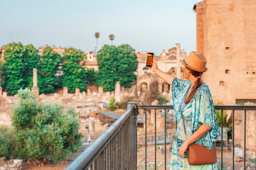 08 08 2025 Rome, Italy - Traveler in hat looking at Roman Forum ruins