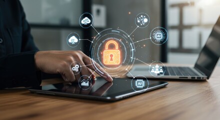 Person using a tablet with a padlock graphic overlay and a laptop.