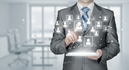 Business person using a tablet with human icon interface in an office.