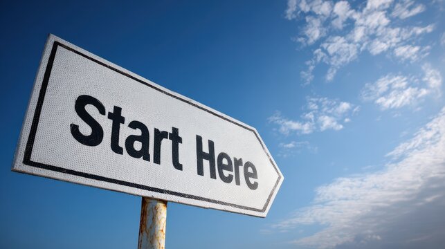Start Here Arrow. Directional Road Signpost in Sky Background