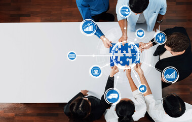 A dynamic overhead view of a diverse group of professionals engaged in a collaborative business meeting, featuring icons that symbolize growth, data-driven strategies, and innovation. Amity