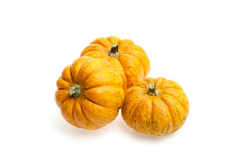 Three vibrant orange pumpkins with textured skin and green stems arranged together, showcasing their natural beauty and seasonal charm for autumn decoration and culinary use