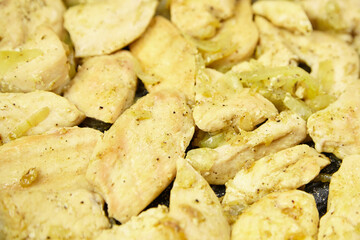 Cooked chicken pieces seasoned with spices and herbs, arranged on a dark surface, showcasing a delicious and appetizing meal ready for serving and enjoyment