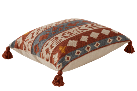 A vibrant square throw pillow featuring a rich terracotta, cream, grey, and yellow geometric pattern, accented with decorative corner tassels. background removed