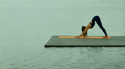 asian hispanic woman practicing yoga Downward Facing Dog Adho Mukha Svanasana Pose stretching exercises muscle for warm up on the beach in Maldives with seaside Feeling so comfortable relax in holiday
