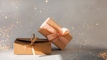 Greeting background. Brown and pink gift boxes on a gray background with copy space. Front view