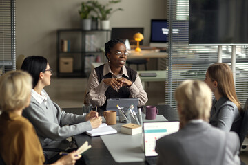 Young Adult Black Woman Leading Business Meeting with Diverse Colleagues