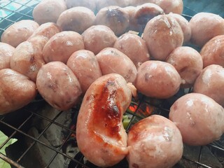 Grilled beef sausages on a charcoal grill