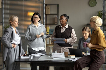 Diverse Group of Middle Aged Women Collaborating during Office Meeting