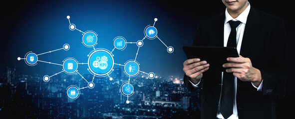 A business professional interacts with a digital tablet, analyzing key performance indicators in a modern urban setting, highlighting data-driven decision-making. Tessel