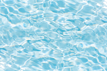 Blue water with ripples on the surface. Defocus blurred transparent blue colored clear calm water surface texture with splashes and bubbles. Water waves with shining pattern texture background.