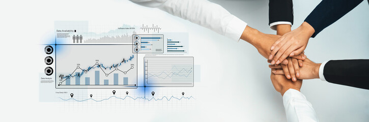 A close-up of multiple hands stacked together, symbolizing teamwork and collaboration, backed by...