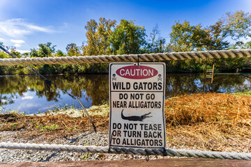 Alligator safety sign near swamp access, South Louisiana, USA