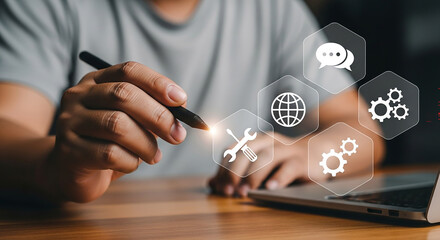 Digital Interaction: A person, pen in hand, interacts with glowing, interconnected icons, symbolizing digital solutions, innovation, and technological advancements.