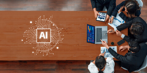 A diverse team of professionals collaborates on an artificial intelligence project, utilizing technology to analyze data and develop innovative strategies in a modern workspace. Trope