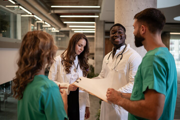 Fototapeta premium Diverse medical team collaborating on patient records