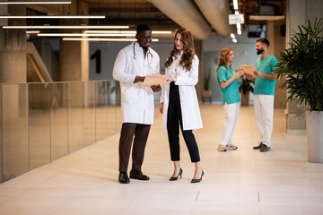 Fototapeta premium Doctors and nurses discussing medical patient notes
