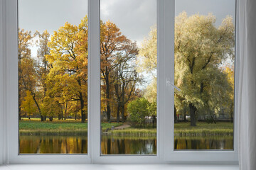 Window frame, view from the window  on yellow trees, landscape with autumn forest.