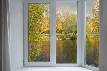 Window frame, view from the window  on yellow trees, landscape with autumn forest.