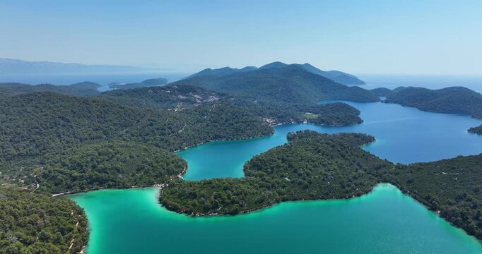 Untouched green islands and turquoise water in Croatia, aerial pull-out