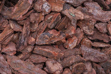 Natural pine bark mulch used for garden decoration and soil protection. Eco-friendly organic material ideal for landscaping and horticulture design projects.