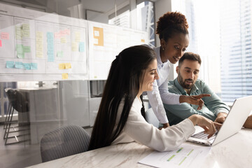 Confident businesswoman guide colleagues through creating business plan on notebook